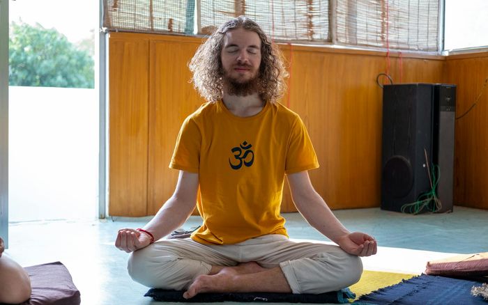 A serene person meditating in a beautifully lit room, symbolizing well-being.